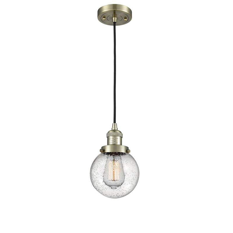 Beacon Mini Pendant shown in the Antique Brass finish with a Seedy shade