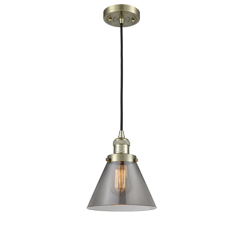 Cone Mini Pendant shown in the Antique Brass finish with a Plated Smoke shade