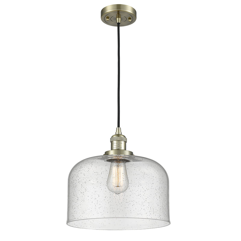 Bell Mini Pendant shown in the Antique Brass finish with a Seedy shade