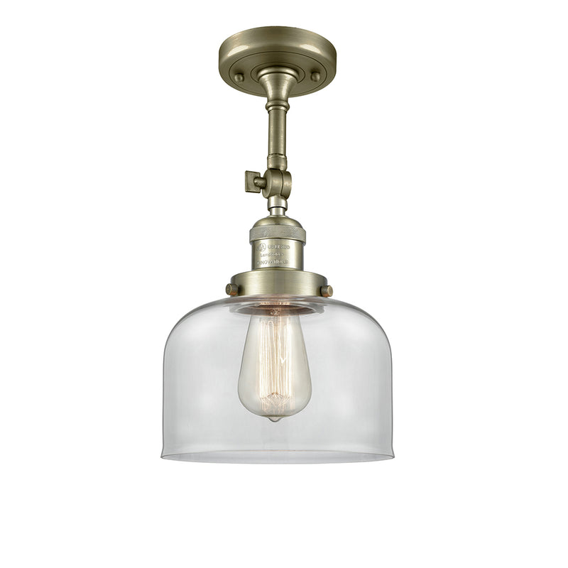 Bell Semi-Flush Mount shown in the Antique Brass finish with a Clear shade