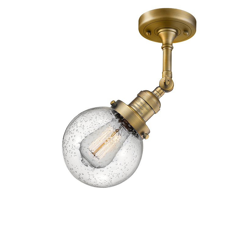 Beacon Semi-Flush Mount shown in the Brushed Brass finish with a Seedy shade