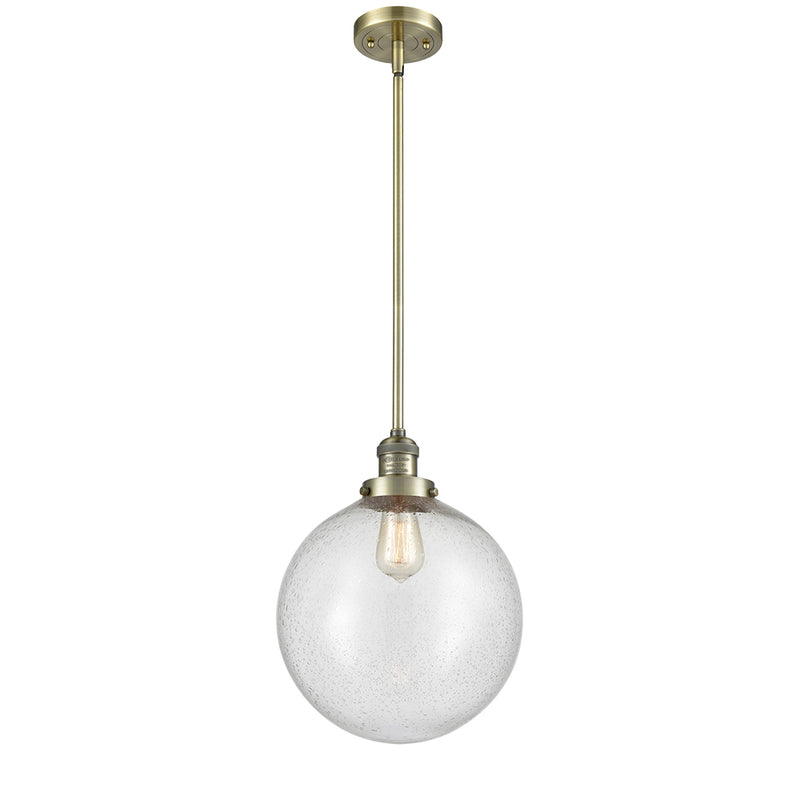 Beacon Mini Pendant shown in the Antique Brass finish with a Seedy shade