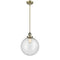 Beacon Mini Pendant shown in the Antique Brass finish with a Seedy shade