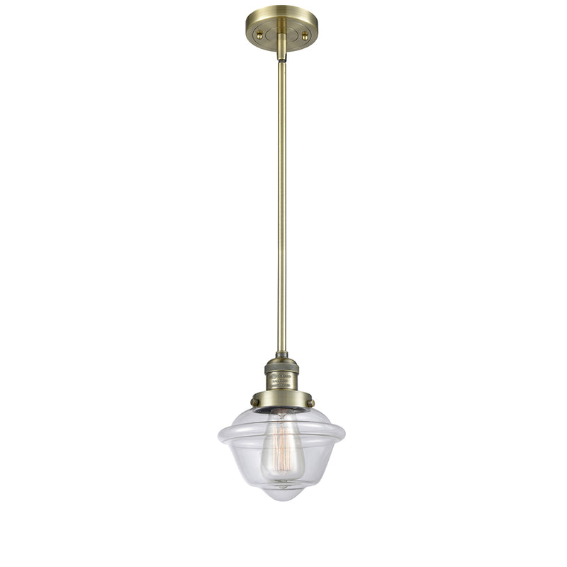 Oxford Mini Pendant shown in the Antique Brass finish with a Clear shade