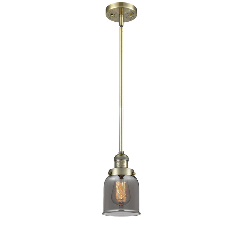 Bell Mini Pendant shown in the Antique Brass finish with a Plated Smoke shade