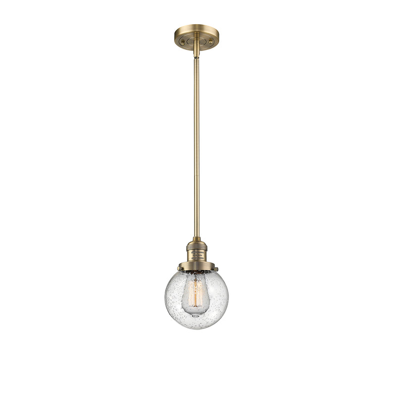 Beacon Mini Pendant shown in the Brushed Brass finish with a Seedy shade