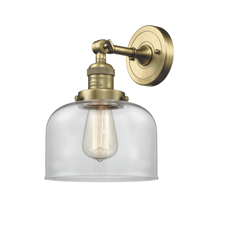 Innovations Lighting Large Bell 1-100 watt 8 inch Antique Brass Sconce with Clear glass and Solid Brass 180 Degree Adjustable Swivel With Engraved Cast Cup 203ABG72