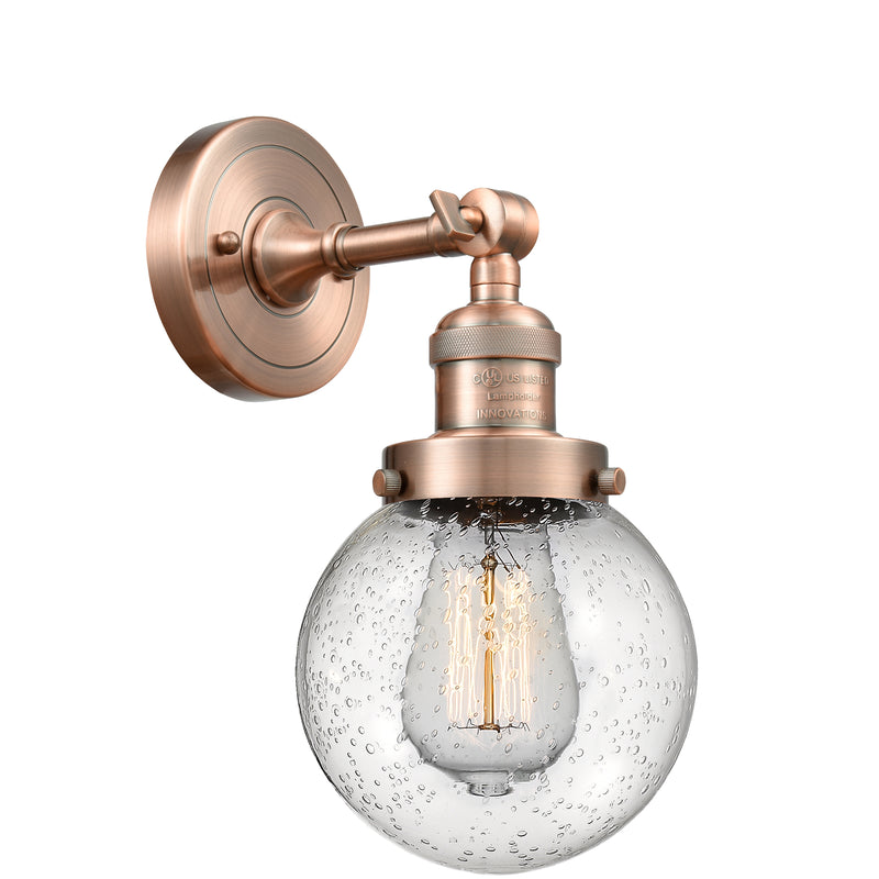 Beacon Sconce shown in the Antique Copper finish with a Seedy shade