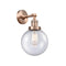 Beacon Sconce shown in the Antique Copper finish with a Seedy shade