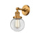 Beacon Sconce shown in the Brushed Brass finish with a Clear shade