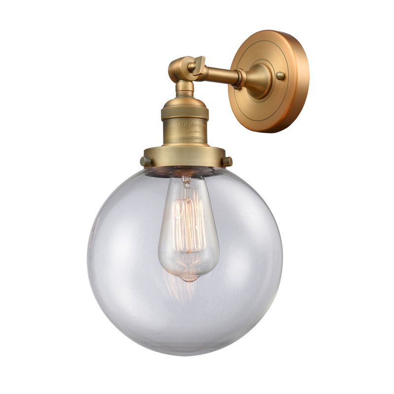 Beacon Sconce shown in the Brushed Brass finish with a Clear shade