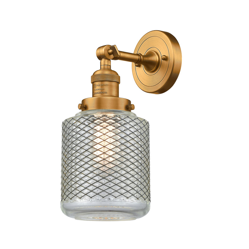 Stanton Sconce shown in the Brushed Brass finish with a Clear Wire Mesh shade