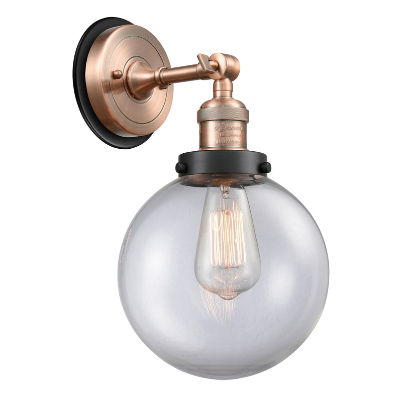 Beacon Sconce shown in the Antique Copper finish with a Clear shade