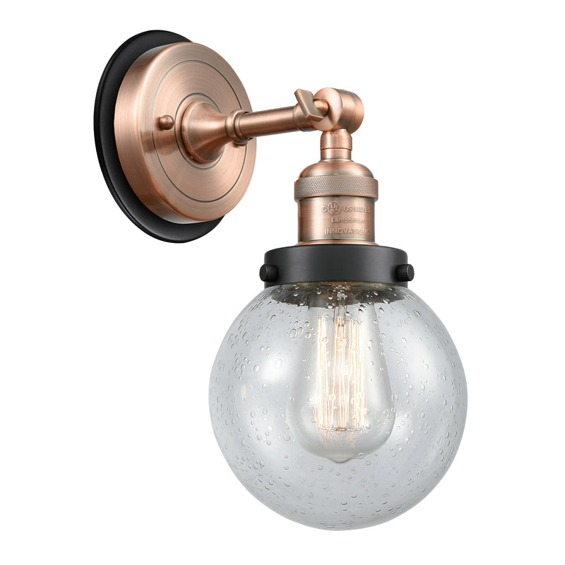 Beacon Sconce shown in the Antique Copper finish with a Seedy shade