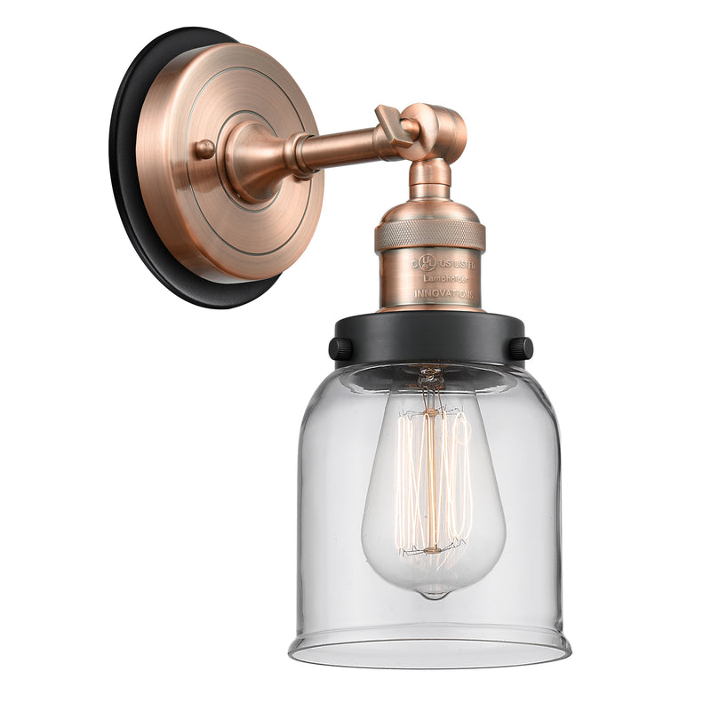 Bell Sconce shown in the Antique Copper finish with a Clear shade