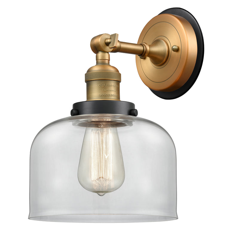 Bell Sconce shown in the Brushed Brass finish with a Clear shade