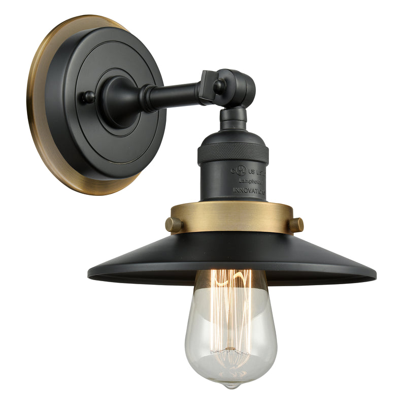 Railroad Sconce shown in the Matte Black finish with a Antique Copper shade