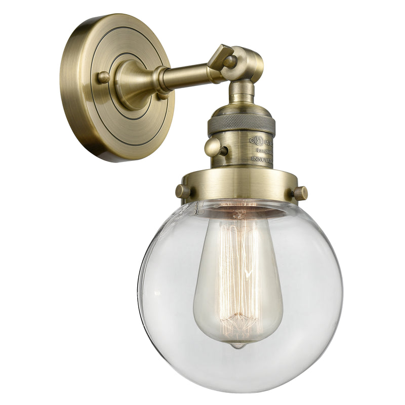 Beacon Sconce shown in the Antique Brass finish with a Clear shade