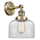 Bell Sconce shown in the Antique Brass finish with a Clear shade