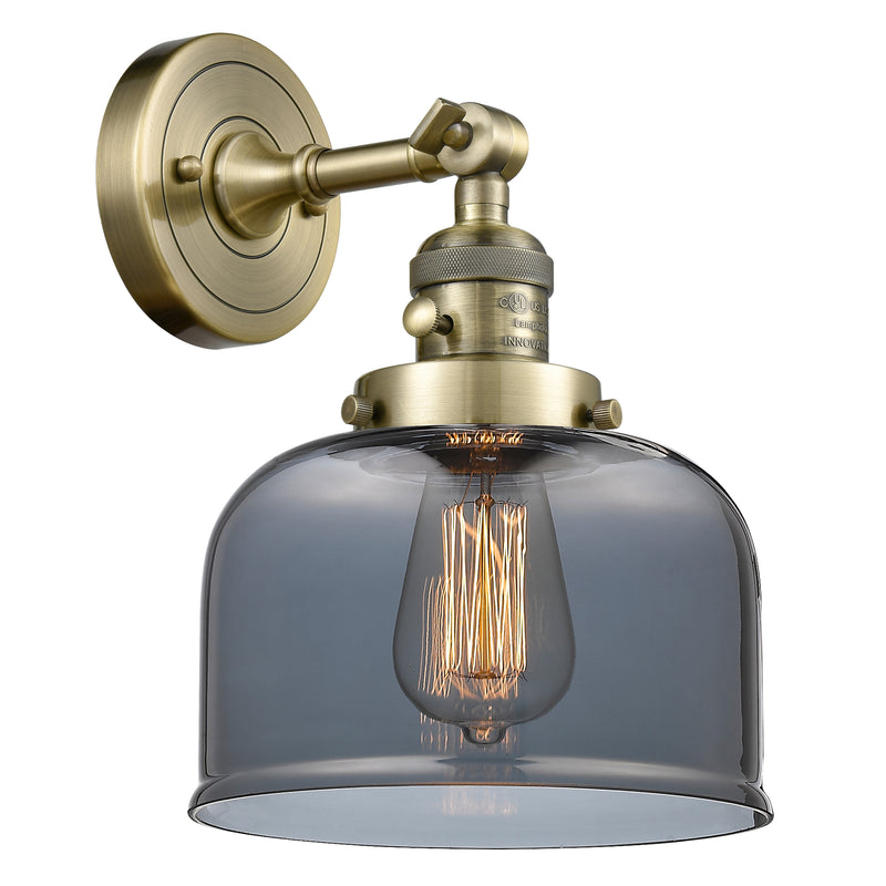 Bell Sconce shown in the Antique Brass finish with a Plated Smoke shade