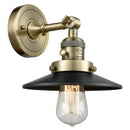 Railroad Sconce shown in the Antique Brass finish with a Matte Black shade