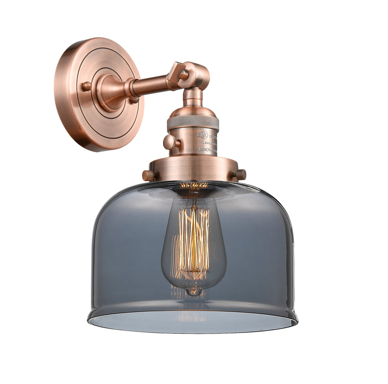 Innovations Lighting Large Bell 1-100 watt 8 inch Antique Copper Sconce with Smoked glass and Solid Brass 180 Degree Adjustable Swivel With Engraved Cast Cup Includes a "High-Low-Off" Switch. 203SWACG73