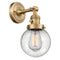 Beacon Sconce shown in the Brushed Brass finish with a Seedy shade