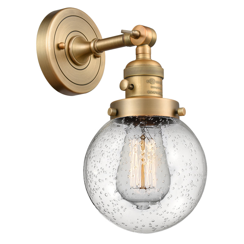 Beacon Sconce shown in the Brushed Brass finish with a Seedy shade