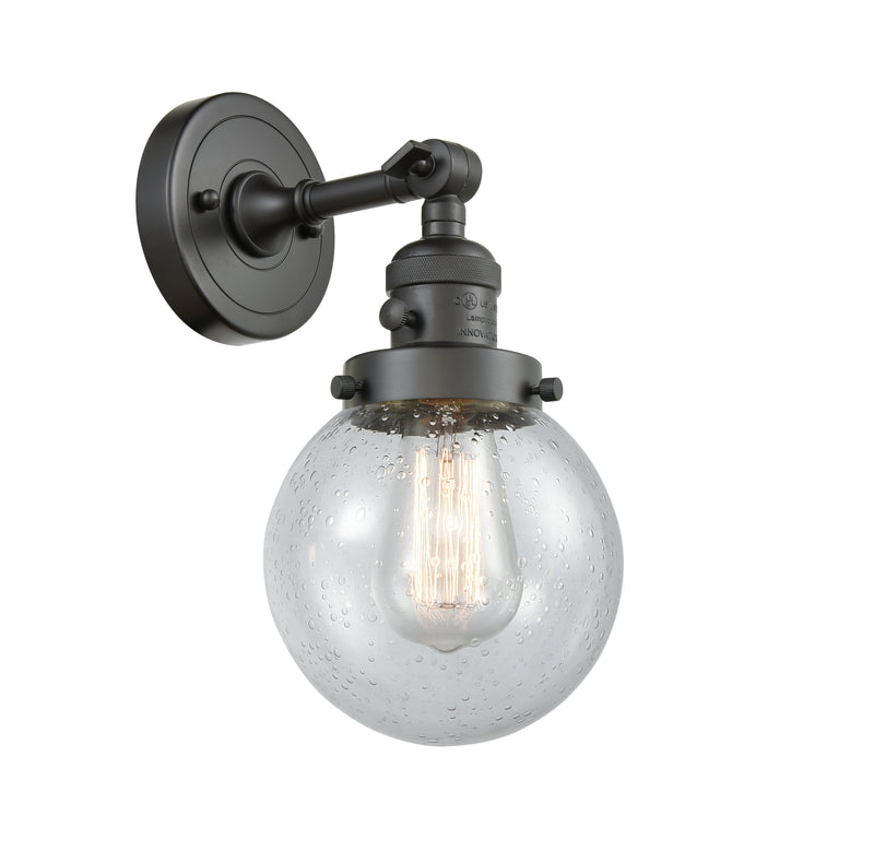 Innovations Lighting Beacon 1-100 watt 6 inch Oil Rubbed Bronze Sconce with Seedy glass and Solid Brass 180 Degree Adjustable Swivel With Engraved Cast Cup Includes a "High-Low-Off" Switch. 203SWOBG2046