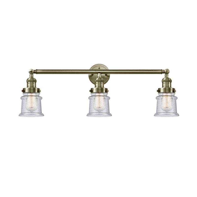 Canton Bath Vanity Light shown in the Antique Brass finish with a Seedy shade