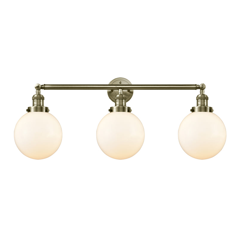 Beacon Bath Vanity Light shown in the Antique Brass finish with a Matte White shade