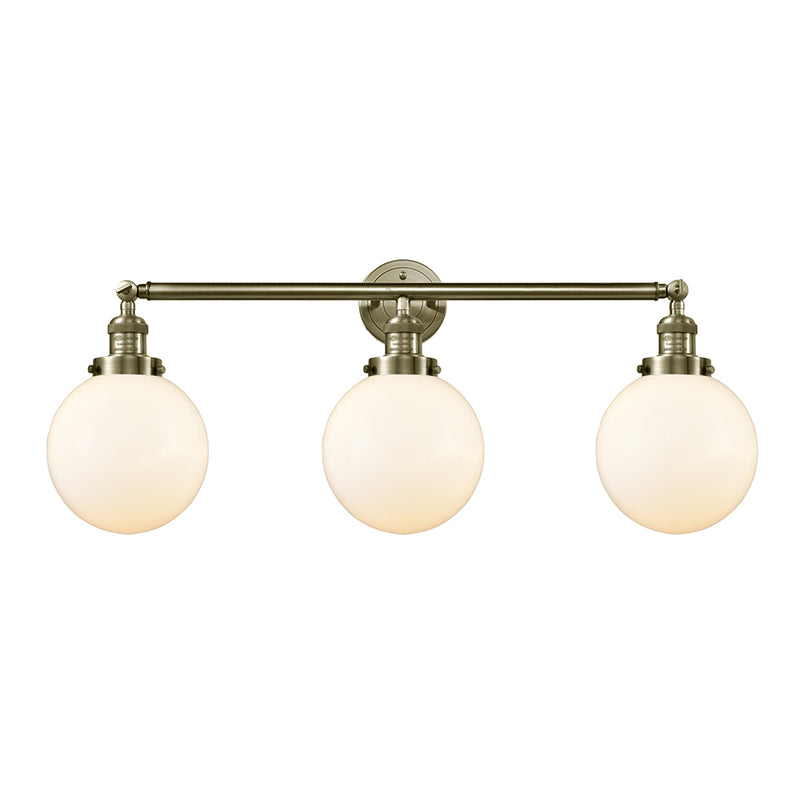 Beacon Bath Vanity Light shown in the Antique Brass finish with a Matte White shade