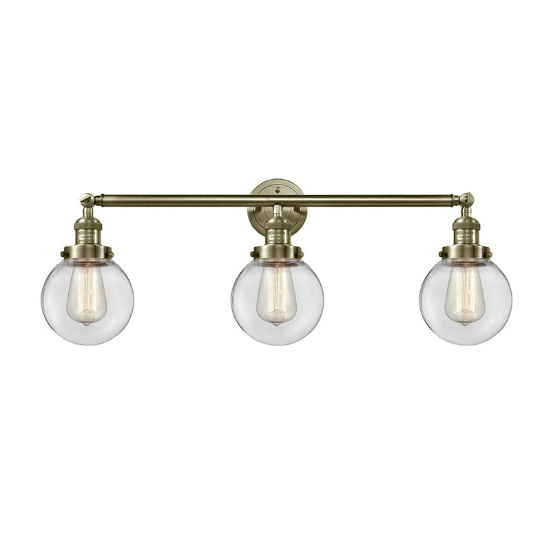 Beacon Bath Vanity Light shown in the Antique Brass finish with a Clear shade