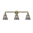 Cone Bath Vanity Light shown in the Antique Brass finish with a Plated Smoke shade