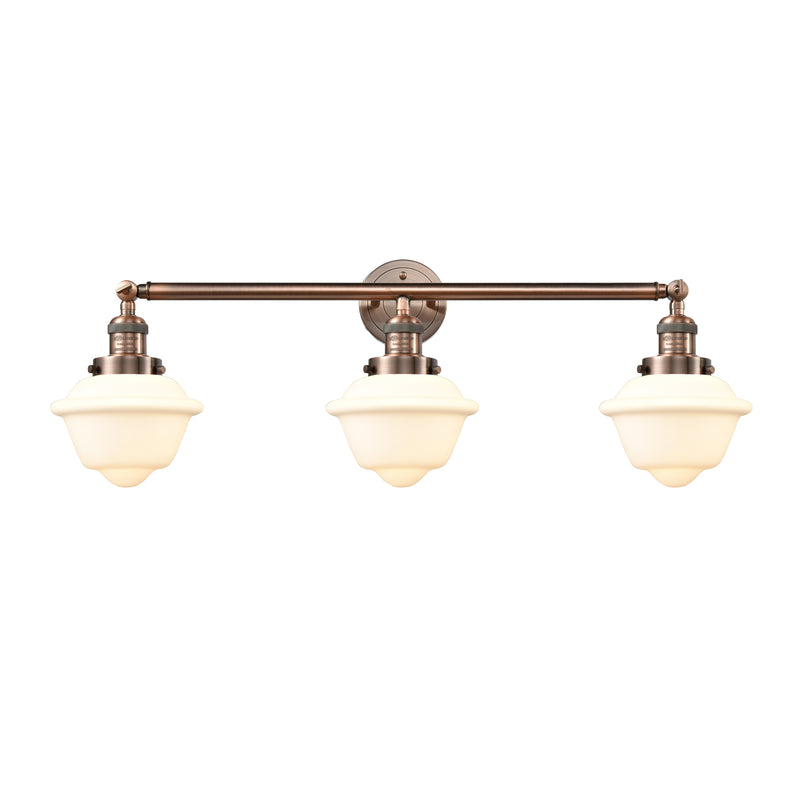 Oxford Bath Vanity Light shown in the Antique Copper finish with a Matte White shade