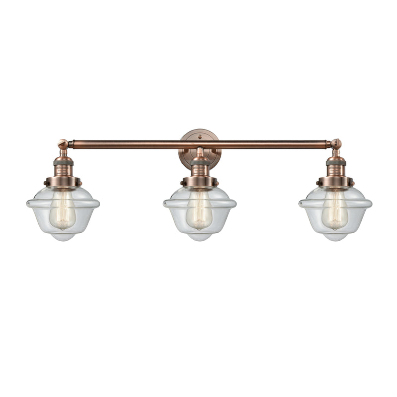 Oxford Bath Vanity Light shown in the Antique Copper finish with a Clear shade