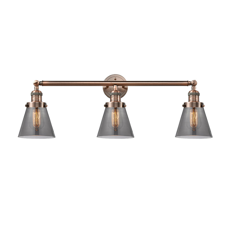 Cone Bath Vanity Light shown in the Antique Copper finish with a Plated Smoke shade