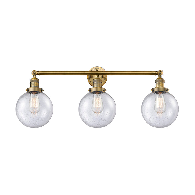 Beacon Bath Vanity Light shown in the Brushed Brass finish with a Seedy shade