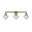 Oxford Bath Vanity Light shown in the Brushed Brass finish with a Clear shade