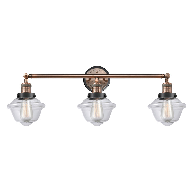 Oxford Bath Vanity Light shown in the Antique Copper finish with a Clear shade