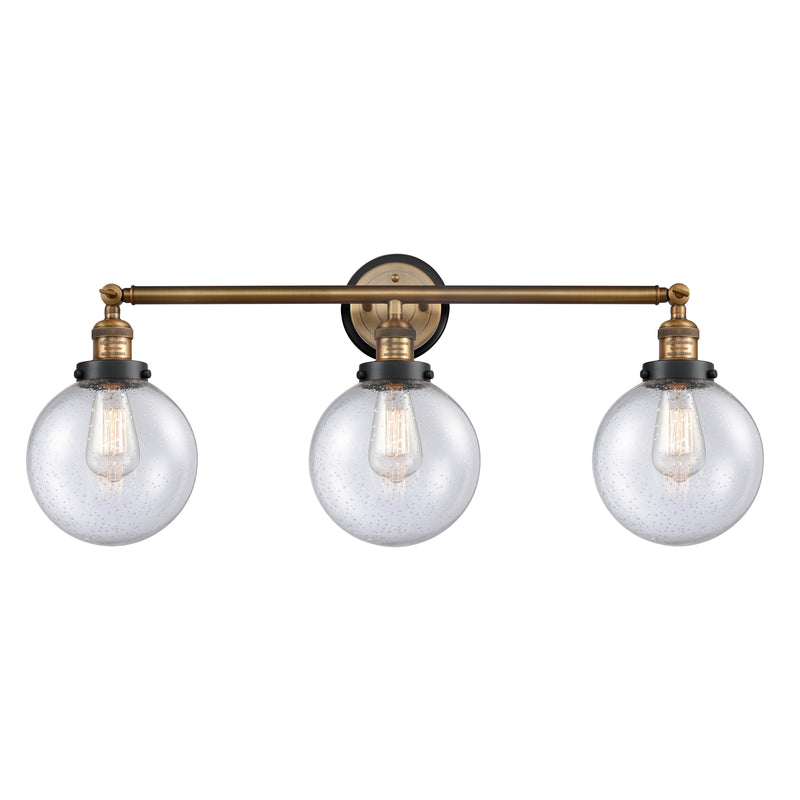 Beacon Bath Vanity Light shown in the Brushed Brass finish with a Seedy shade