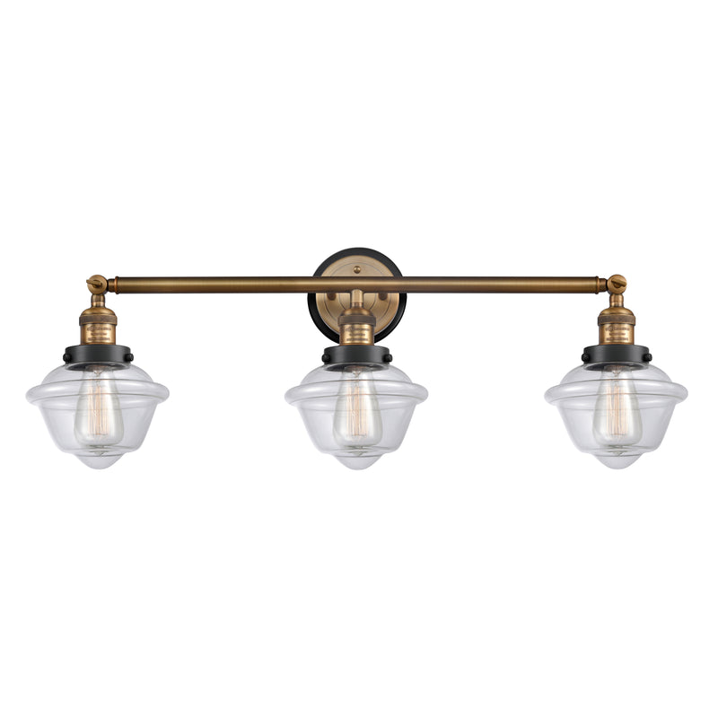 Oxford Bath Vanity Light shown in the Brushed Brass finish with a Clear shade