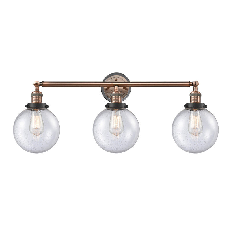 Beacon Bath Vanity Light shown in the Antique Copper finish with a Seedy shade