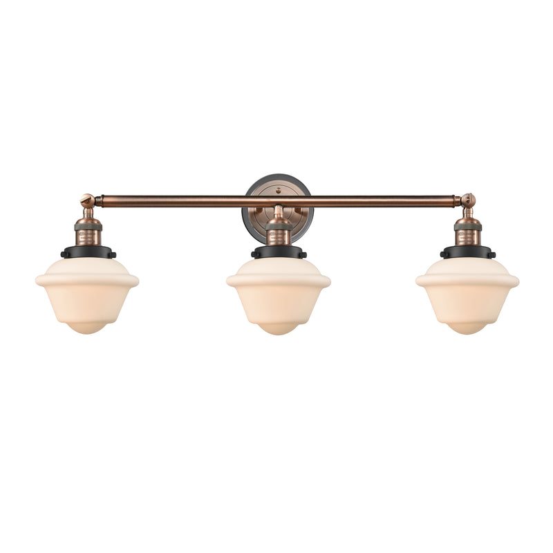 Oxford Bath Vanity Light shown in the Antique Copper finish with a Matte White shade