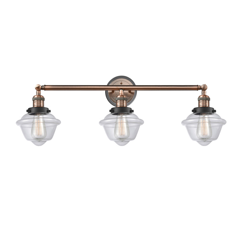 Oxford Bath Vanity Light shown in the Antique Copper finish with a Clear shade