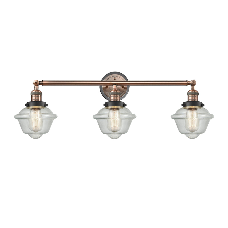 Oxford Bath Vanity Light shown in the Antique Copper finish with a Seedy shade