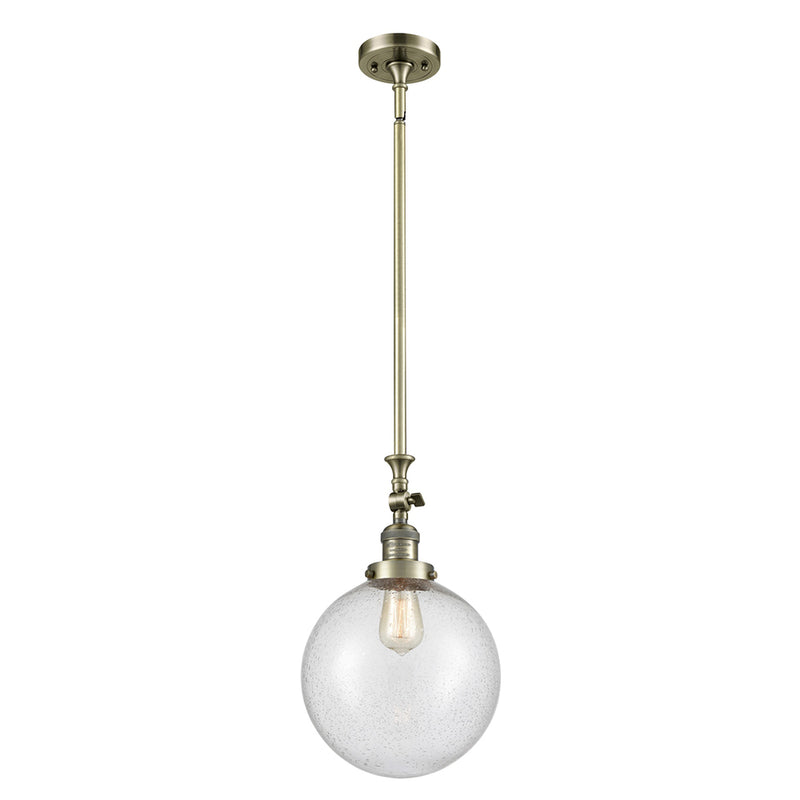 Beacon Mini Pendant shown in the Antique Brass finish with a Seedy shade