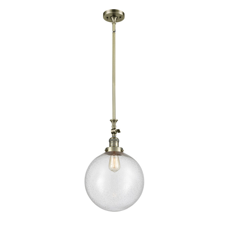 Beacon Mini Pendant shown in the Antique Brass finish with a Seedy shade