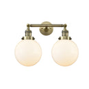 Beacon Bath Vanity Light shown in the Antique Brass finish with a Matte White shade