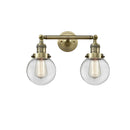 Beacon Bath Vanity Light shown in the Antique Brass finish with a Clear shade